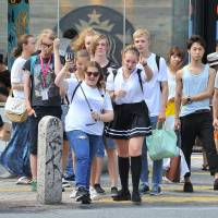 Foreign tourists are seen in Tokyo’s bustling Shibuya district. Overseas visitors to Japan set January-August record topping 18.9 million