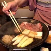 Classic combination: An attendant prepares a serving of Ningyocho Imahan’s old-school sukiyaki. Ningyocho Imahan: An old take on an old favorite — sukiyaki