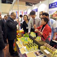 What a spread: Pakistan Ambassador Farukh Amil tastes halal foods at the Japan Halal Expo 2014. Japan's halal industry gathers pace but experts say there's more to do