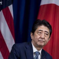 Eyes right: Prime Minister Shinzo Abe waits for a meeting with U.S. President Donald Trump at the Palace Hotel in New York on Thursday. In Japan under Shinzo Abe, more power to the PM, but to what end?
