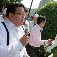 Hate on the mic: Makoto Sakurai, then the leader of the anti-Korean rightist group Zaitokukai, speaks outside Yasukuni Shrine in Tokyo on Aug. 15, 2009. Running as a candidate in Tokyo’s gubernatorial election last year, he pledged to pass legislation banning “harassment of Japanese based on fabricated history,” which he called “anti-Japanese hate speech. “ Japan doesn't need to criminalize hate speech