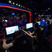Attendees play Activision Blizzard Inc.’s Overwatch game at the AOC Open e-Sports event in Tokyo on July 1. Japan has been slow to embrace e-sports, but that may change. Japan's 'Super Mario Syndrome'
