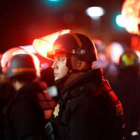 Police officers stand in a line as others render aid to an injured woman during a protest against a speech by conservative political commentator Ben Shapiro at UC Berkeley in Berkeley, California, on Sept. 14. Security for the event cost an estimated $600,000. Americans feared Trump, but normalized leftist violence