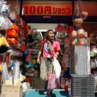 New hope: Tokuchika Nishi, a 38-year-old homeless man who says joining the dance group Newcomer “H” Sokerissa!, changed his life, steps out of a ¥100 shop in Tokyo. Dancing to the tune of humanity