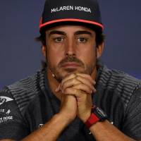McLaren Honda driver Fernando Alonso addresses a news conference in Singapore on Thursday. F1 shake-up: McLaren to end partnership with engine supplier Honda, begin working with Renault