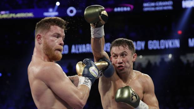 Gennady Golovkin (right) throws a punch at Canelo Alvarez during their fight in Las Vegas on Saturday. The match was ended in a draw. Alvarez, Canelo battle to draw in long-awaited bout