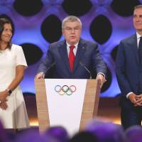 IOC president Thomas Bach speaks between Paris Mayor Anne Hidalgo and Los Angeles Mayor Eric Garcetti after Paris 2024 and Los Angeles 2028 were ratified as host cities for the Olympics during the IOC session in Lima on Wednesday. IOC formally awards Paris 2024 Olympics, LA 2028 Games