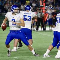 BigBlue quarterback Kevin Craft drops back to pass against the Seagulls in their X League season opener on Tuesday night at Tokyo Dome. BigBlue continue to progress