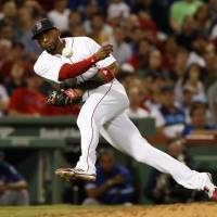 Red Sox third baseman Eduardo Nunez throws out Toronto’s Jose Bautista during Boston’s 3-2 win at Fenway Park on Tuesday. Red Sox top Blue Jays in 19-inning marathon