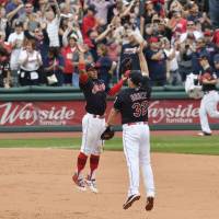 Cleveland shortstop Francisco Lindor (left) and right fielder Jay Bruce celebrate their American League record 21st straight victory over the Detroit Tigers on Wednesday. Indians establish AL record with 21st consecutive win
