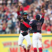 Indians outfielder Austin Jackson (left) celebrates with shortstop Francisco Lindor after the team’s win over the Royals on Saturday in Cleveland. Tribe clinches AL Central