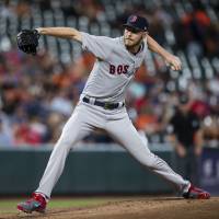 Boston’s Chris Sale pitches during the first inning of the Red Sox’s 9-0 win over the Orioles in Baltimore on Wednesday. Sale reaches 300 strikeouts as Red Sox clinch playoff berth
