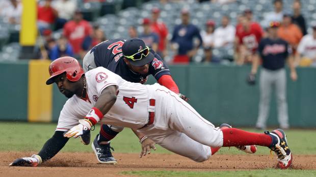 Cleveland shortstop Francisco Lindor tags out Los Angeles’ Brandon Phillips in the first inning on Thursday. Indians continue historic stretch