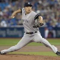 New York starter Masahiro Tanaka pitches against Toronto in the first inning on Friday night. Blue Jays pounce on Tanaka