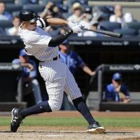 New York slugger Aaron Judge connects in the third inning against Kansas City for the first of his two home runs on the day to set a new rookie record with 50 for the season. Yankees' Judge breaks rookie home run record