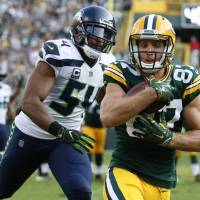 Packers receiver Jordy Nelson catches a touchdown pass in front of Seahawks linebacker Bobby Wagner during the third quarter of their game on Sunday in Green Bay, Wisconsin. The Packers won 17-9. Packers rise to occasion in opening game