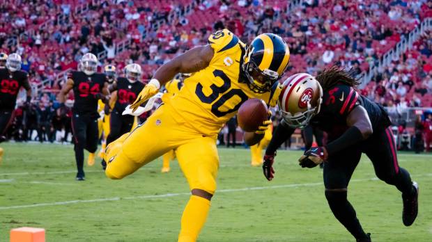 Los Angeles’ Todd Gurley scores a touchdown against San Francisco’s Ray-Ray Armstrong in the first quarter on Thursday night. Rams outscore rival 49ers in wild shootout
