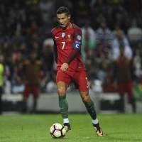 Portugal’s Cristiano Ronaldo moves the ball against the Faroe Islands in a World Cup qualifier in Porto on Thursday night. Portugal won 5-1. Ronaldo scores three, passes Pele in victory