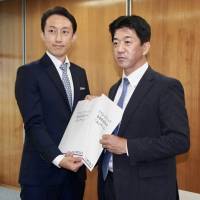T-League managing director Koji Matsushita (right) and a Kinoshita Group Holdings representative hold the company’s application forms to participate in the new table tennis circuit on Friday in Tokyo. T-League unveils ambitious details for inaugural 2018 season, beyond