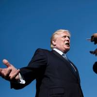 U.S. President Donald Trump speaks to the press while boarding Air Force One at Morristown Airport in Morristown, New Jersey, Sunday. Trump denied stoking racial tensions on Monday, insisting his charged comments that prompted a wave of symbolic protests by NFL players were about patriotism. After his verbal attacks on black athletes led players across the country to kneel in solidarity during the U.S. national anthem at games over the weekend, the besieged president played defense on Twitter. Trump again blasts NFL for anthem protests, claims they're not about racism