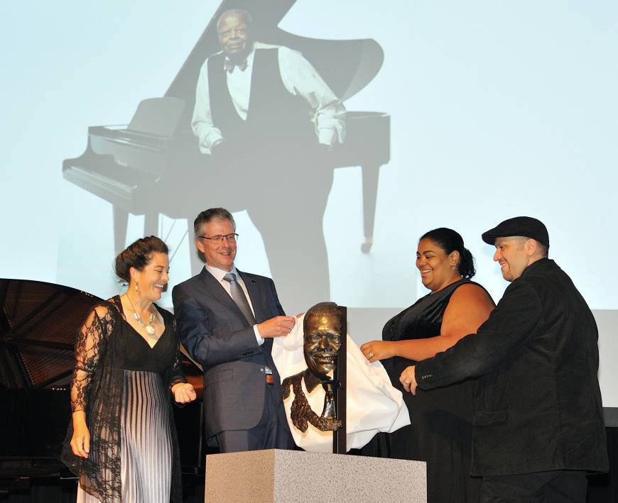 Canadian Ambassador Ian Burney (second from left) and Celine Peterson (second from right) unveil a bronze bust of jazz painist Oscar Peterson at the Canadian Embassy on Sept. 1. Sculptor Ruth Abernethy (left) and jazz pianist Robi Botos were on stage to witness the event.