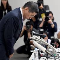 Nissan Motors CEO Hiroto Saikawa bows at the end of a news conference over the recent inspection scandal at the automaker’s headquarters in Yokohama, Kanagawa Prefecture, on Thursday. Nissan says unauthorized checks continued at four plants