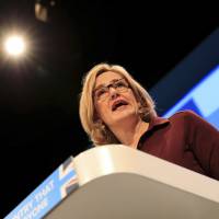 Britain’s Home Secretary Amber Rudd speaks at the Conservative party conference at the Manchester Central Convention Complex in Manchester, England, Tuesday. The British government says it will make streaming extremist content an offense punishable by up to 15 years in prison. Currently it’s illegal to download or store material that encourages violent attacks. But Rudd says the law should be toughened to include “people who repeatedly view terrorist content online.” U.K. says pedophiles, organized crime using WhatsApp with impunity, demands access to messages