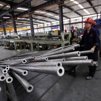 Workers are seen in a Qinghai Guoxin Aluminum Industry Inc. Co. workshop in Xining, Qinghai province, on Friday. At 3.95 percent, China says jobless rate is at its lowest in years, but challenges persist