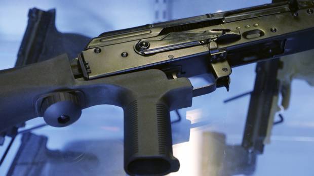 A device called a “bump stock” is attached to a semi-automatic rifle at the Gun Vault store and shooting range in South Jordan, Utah, on Oct. 4. Las Vegas shooting didn't change Americans' opinions on gun control, poll indicates