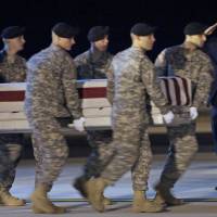 Then-President Barack Obama salutes as an Army carry team carries the transfer case containing the remains of Sgt. Dale R. Griffin of Terre Haute, Indiana, in 2009 during a casualty return at Dover Air Force Base, Delaware. President Donald Trump is claiming his predecessors did not sufficiently honor the nation’s fallen. His accusation that most presidents did not call families of military personnel is provoking a heated response. Trump draws stern rebuke, branded a liar after claiming predecessors didn't honor fallen service members