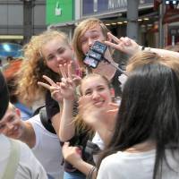 Tourists from abroad take a photo in the Shibuya district of Tokyo. Japan welcomes record 13.34 million overseas visitors in first half of 2017