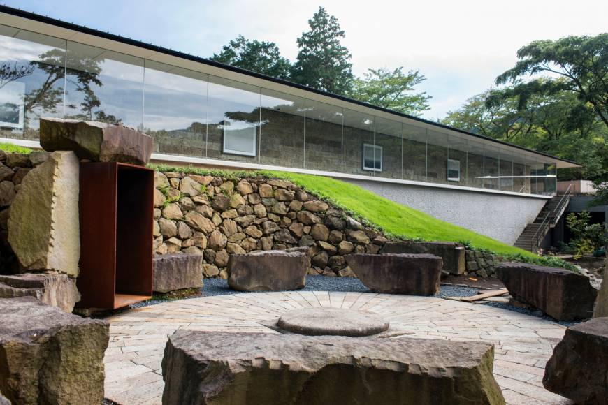 A small open-air theater surrounded by stones is located beside the Enoura Oservatory