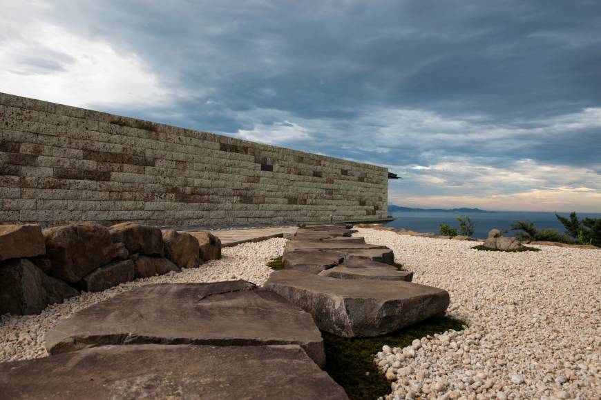 A stone path leads toward the ocean at the Enoura Observatory in Kanagawa Prefecture.