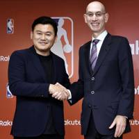 Rakuten CEO Hiroshi Mikitani and NBA commissioner Adam Silver shake hands after announcing a media partnership at a news conference in Tokyo on Tuesday. Rakuten, NBA teaming up in media partnership deal