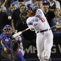 Justin Turner hits a three-run walk-off homer during the Dodgers’ 4-1 win over the Cubs on Sunday in Game 2 of their National League Championship Series. Turner's homer gives Dodgers two-game lead