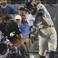 Houston’s George Springer blasts the decisive two-run homer against Los Angeles in the 11th inning of Game 2 of the World Series on Wednesday night. Astros win homer war with Dodgers to even series 1-1