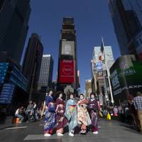 Home and away: Kikuno (center), her maiko apprentice and three other geisha from Kochi and Ehime prefectures traveled to New York to promote geisha culture. Japan's geisha battle to protect their future