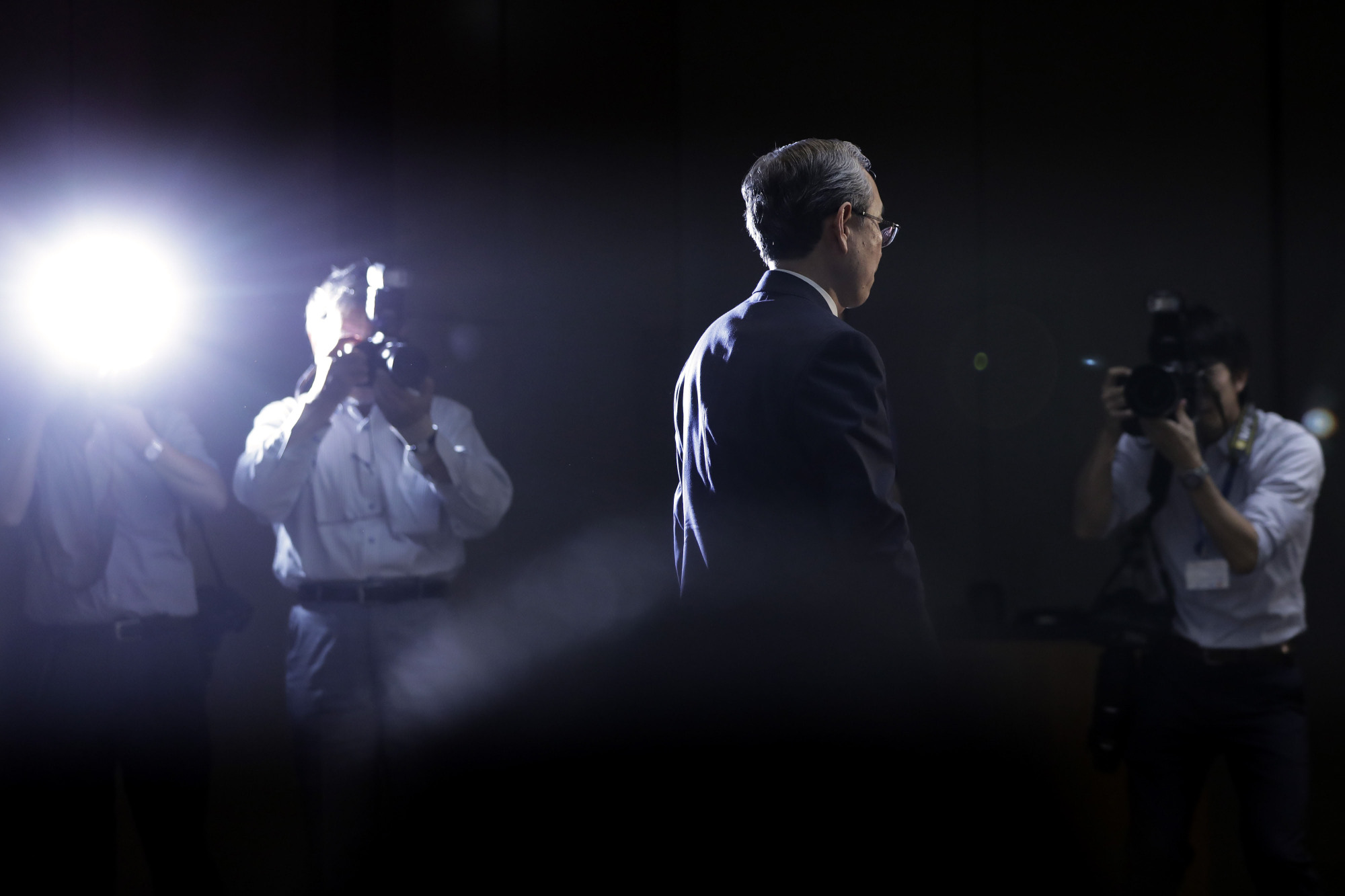 In the glare: Toshiba Corp. President Satoshi Tsunakawa leaves a news conference in August after acknowledging the firm was having trouble selling its memory chip unit.