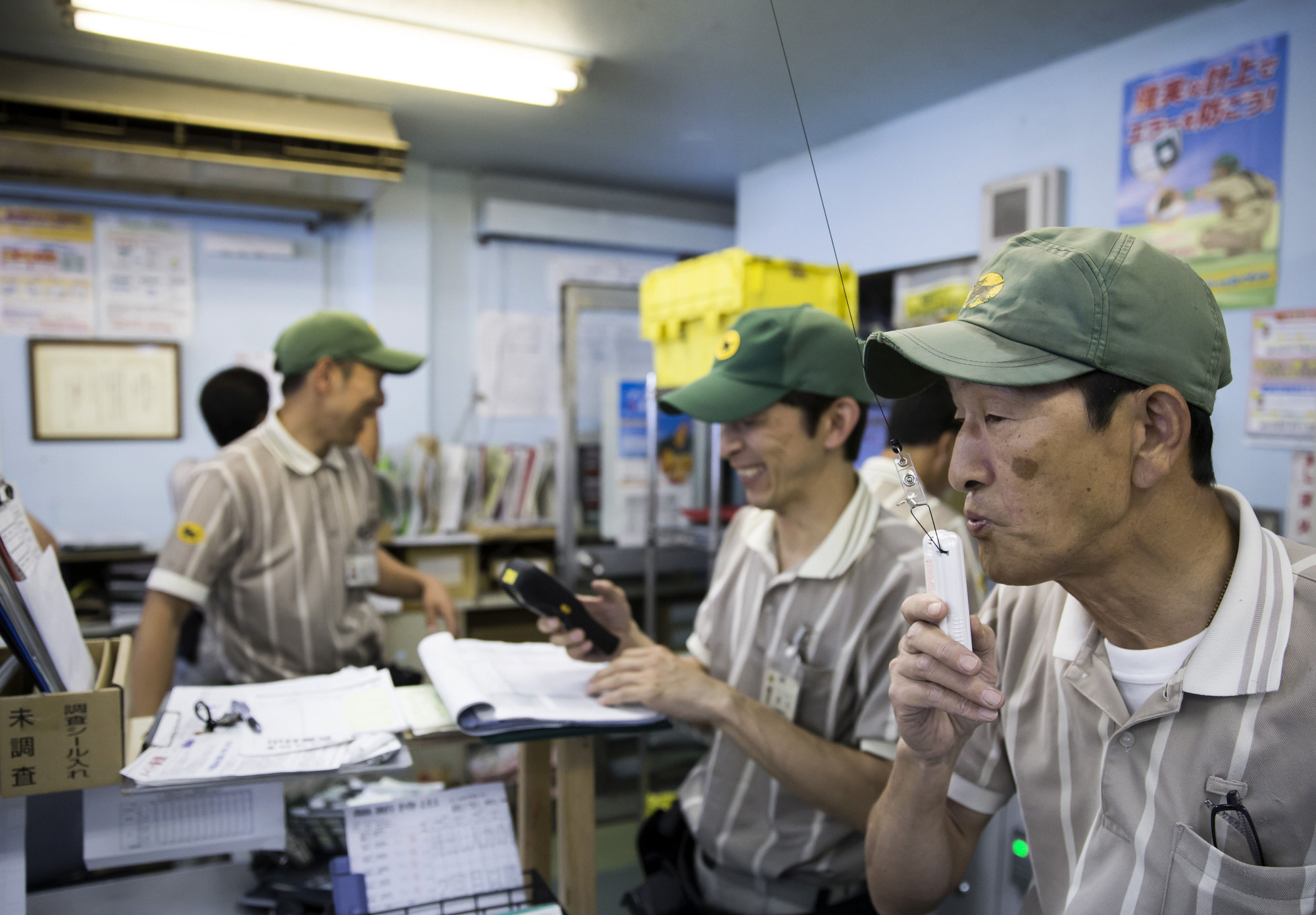On the road: A Yamato Transport Co. driver uses a Breathalyzer before setting off from a branch of the delivery company in May.