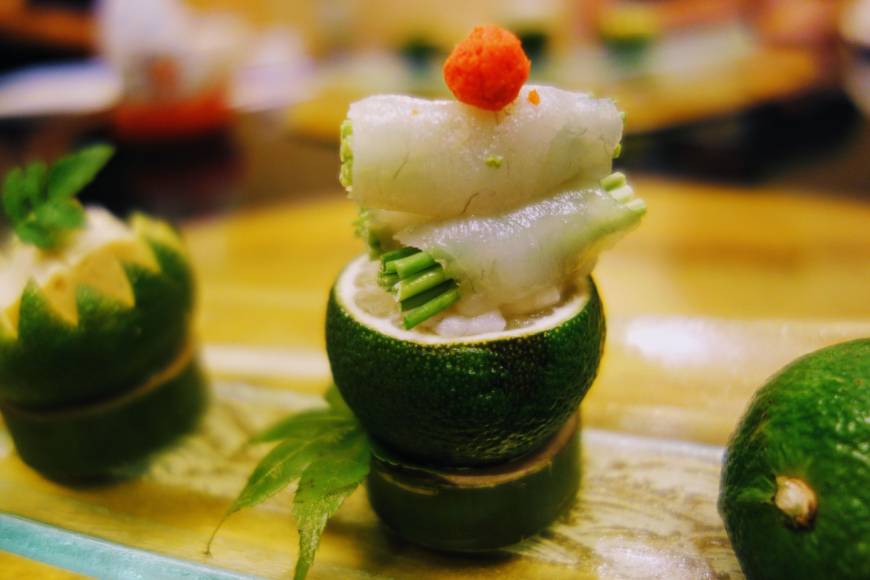Subtle flavor: Fugu (puffer fish) sashimi served on fresh yuzu citron at Yamaguchi Hotel.