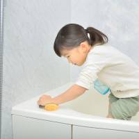 Family business: Scrubbing away at the bath was a task given to kids in the Shoji household. The year-end flurry of mops and madness