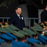Chinese President Xi Jinping, shown attending a Dec. 13 memorial ceremony at the Nanjing Massacre Memorial Hall, has indicated a desire for better Japan-China relations. But the two countries will likely remain regional rivals. Sino-Japanese ties bound to remain stalled