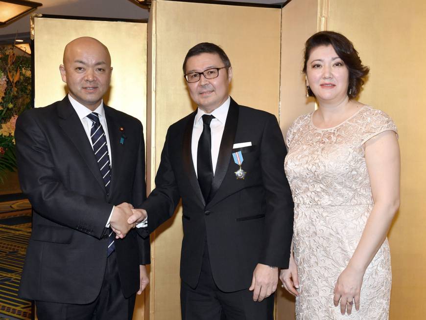 Kazakhstan Ambassador Yerlan Baudarbek-Kozhatayev (center) and his wife, Manshuk, welcome Manabu Horii, parliamentary vice-minister of foreign affairs, during a reception to celebrate of the 26th anniversary of the Republic of Kazakhstan's independence at Hotel Okura Tokyo on Dec. 19. | YOSHIAKI MIURA