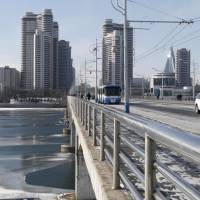 A North Korean woman walks along the Okryu Bridge crossing the partially frozen Taedong River on Jan. 23 in Pyongyang. 60,000 North Korean children may starve as sanctions slow aid, UNICEF warns