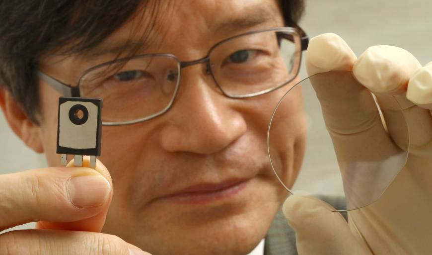 Professor of Engineering Hiroshi Amano holds a power semiconductor (left) and a wafer of crystallized gallium nitride at Nagoya University. His team is working on developing a wireless power supply system using crystallized gallium nitride technology. Nobel winner Hiroshi Amano and his team tap gallium nitride technology in bid to transmit power wirelessly from a distance