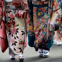 Women wear kimonos during their Coming-of-Age Day celebration ceremony in Tokyo on Jan. 8. Hachioji group leads charge to redo Coming-of-Age Day for women ambushed by kimono firm's failure