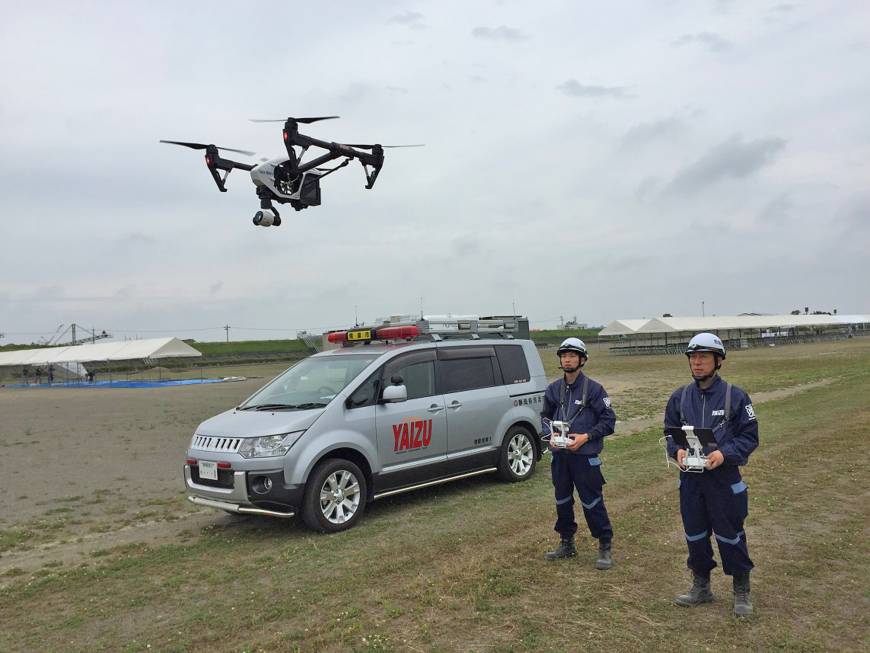Officials from the Yaizu Crisis Management Division use a drone to locate a swimmer in need of help in the ocean as part of an emergency drill.