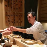 Personal touch: Chef Toshiyuki Suzushi hands a customer freshly made tempura at his Sonoji restaurant. Sonoji