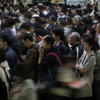Commuters crowd a train station in Tokyo. Japan’s working-age population is forecast to shrink by about 20 million between now and 2050 — a number equivalent to roughly 30 percent of the nation’s current workforce. A prologue to work-style reforms
