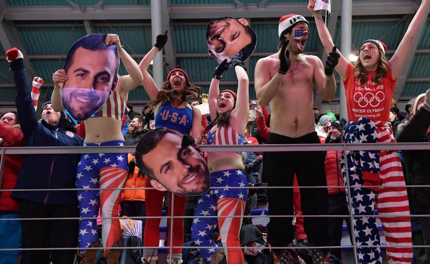 Fans of the USA cheer in the team relay competition luge final at the Olympic Sliding Centre.
